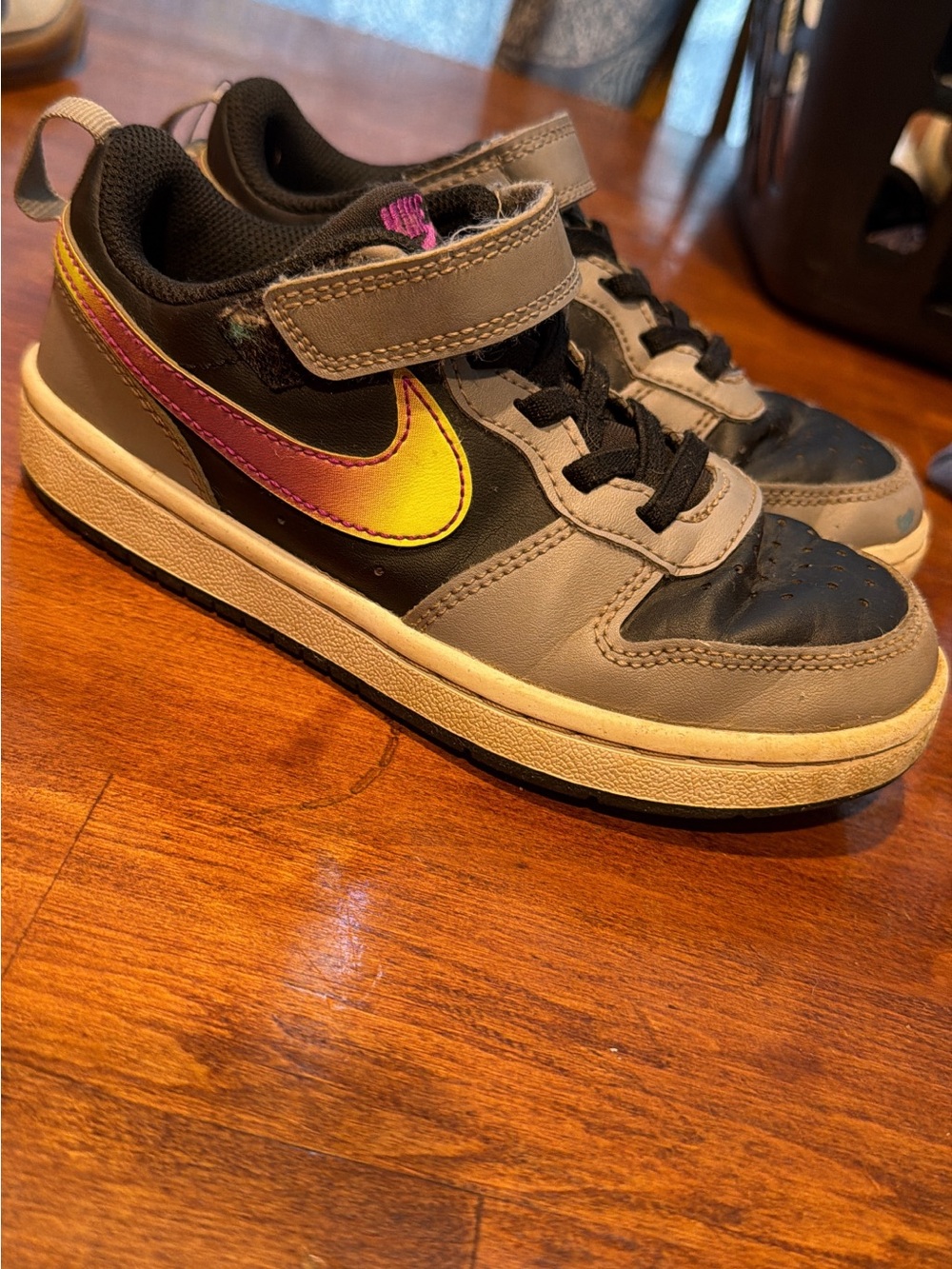 Nike Kids Black and Gray Sneakers with Yellow-to-Pink Gradient Swoosh